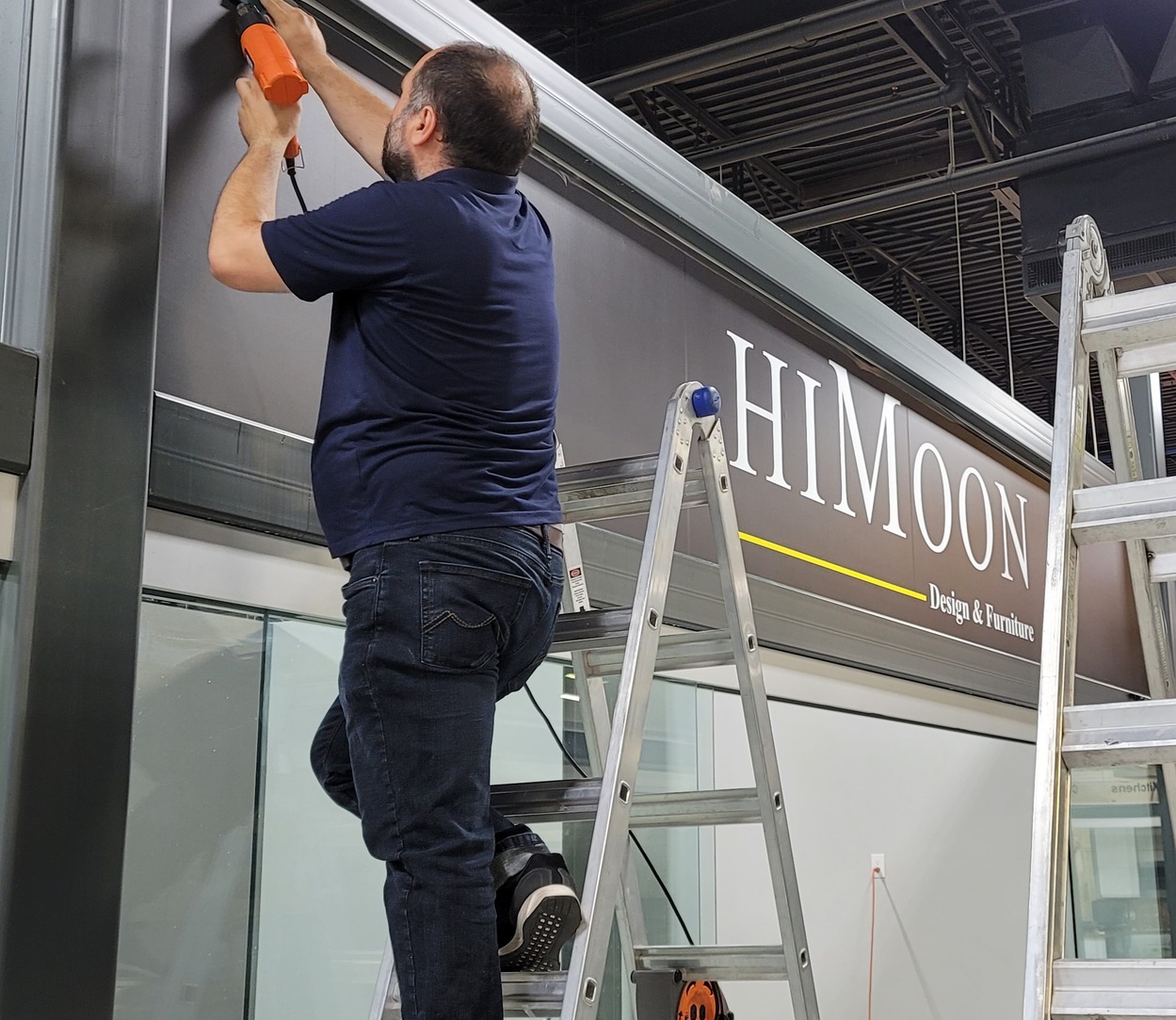 Kerem Sign Employee Installing a sign